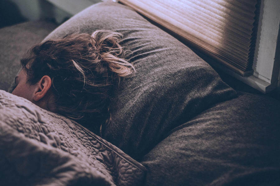 woman lying sideways in bed asleep nurse sleep