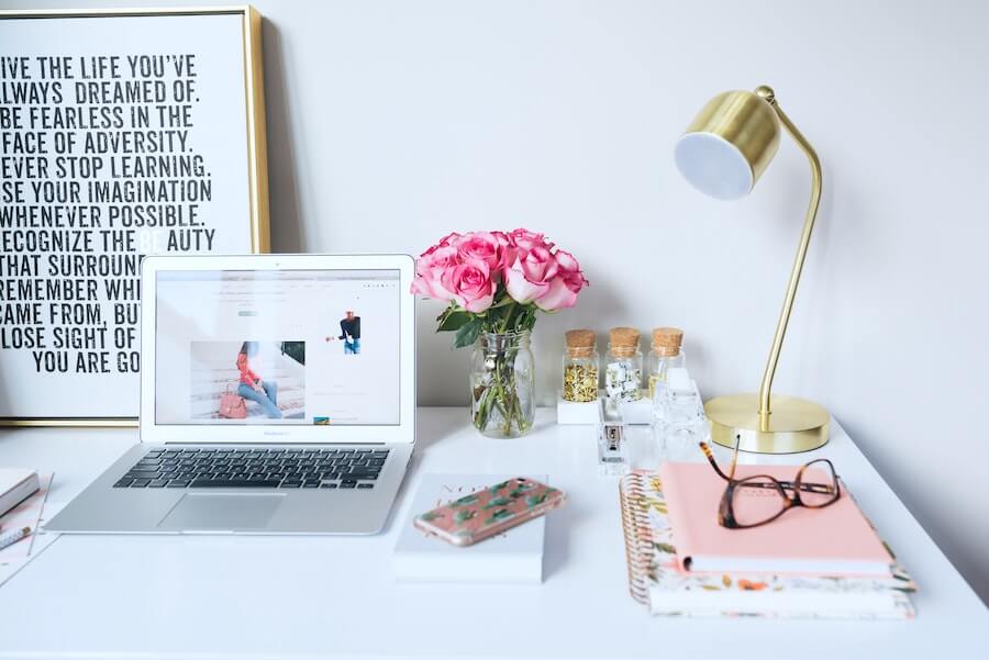 home work desk with computer glasses notebook lamp phone and flower remote nursing jobs top nursing blogs of 2020