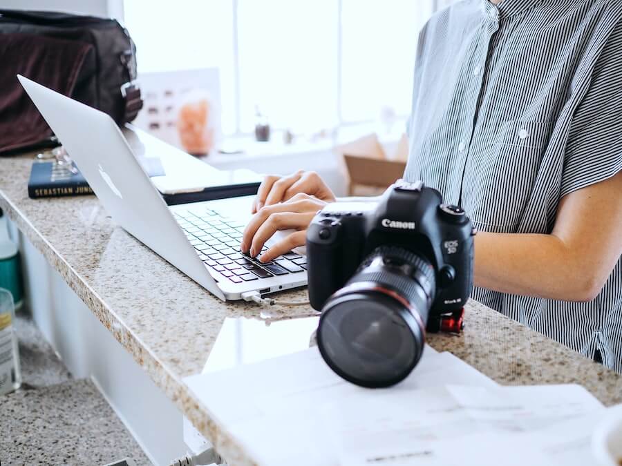 woman looking on computer finishing travel nurse paperwork staff nurse to travel nurse