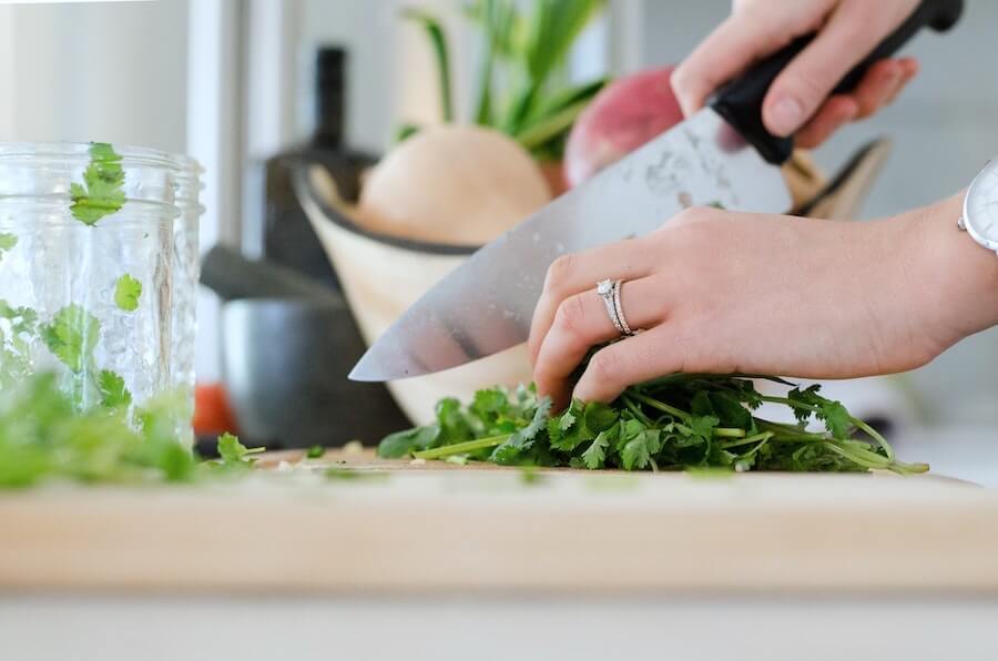 woman cutting cilantro parsley nurse wellness jobs away from the bedside