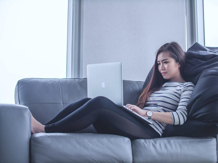 woman with laptop on sofa remote nursing jobs 2021