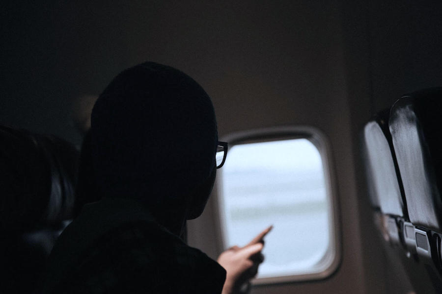 travel nursing for the firs time woman on plane looking out of window