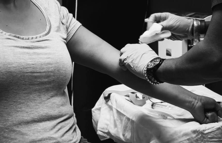 nurse puts bandaid on patient after drawing blood certified nurse midwife cnm