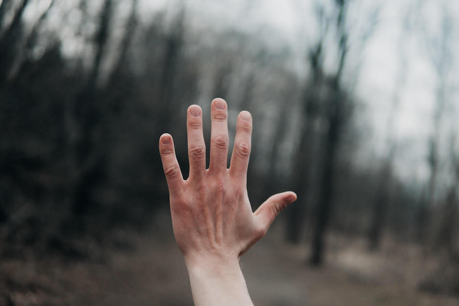 raised hand in front of blurred background nurse advocate