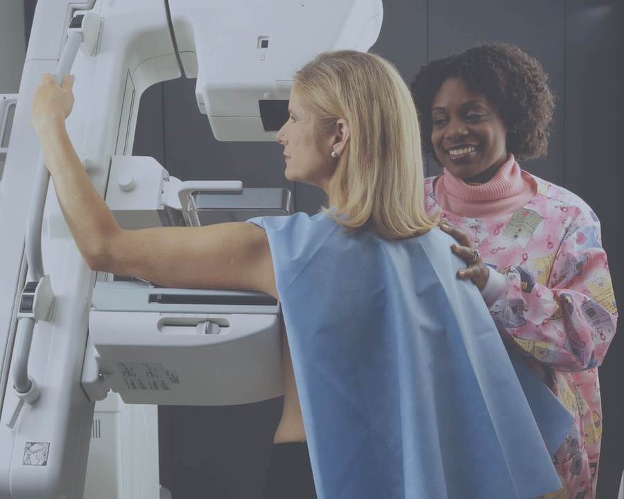 woman getting mammogram with nurse in background oncology nursing