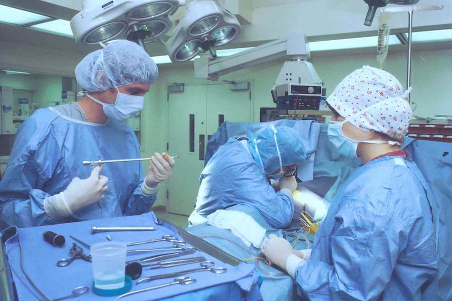 nurses and surgeons in operating room performing a surgery perioperative nurse