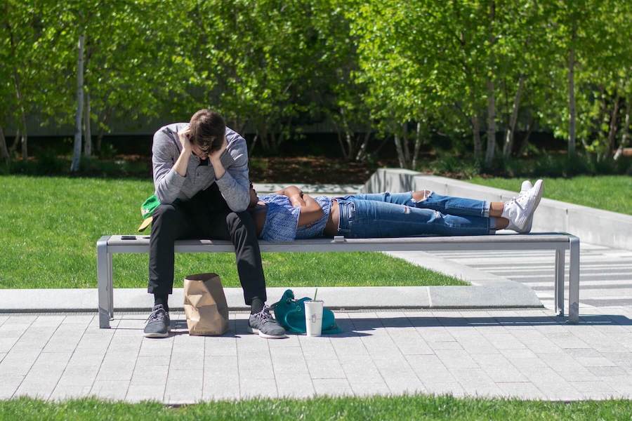 two people siting on bench one laying in the other lap and one with his head down psychiatric nurse practitioner mental health