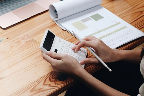 Business woman using calculator