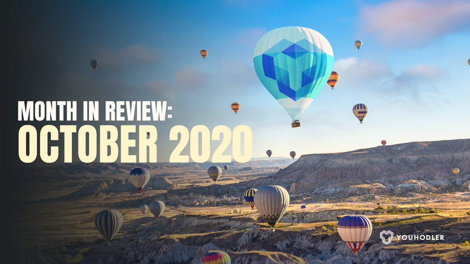 hot air balloons with the youhodler logo flying over a canyon