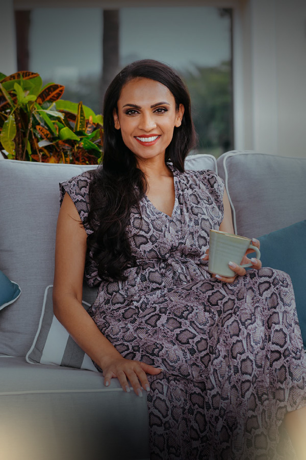 Natasha Rockstrom coaching; sitting in a sofa drinking tea