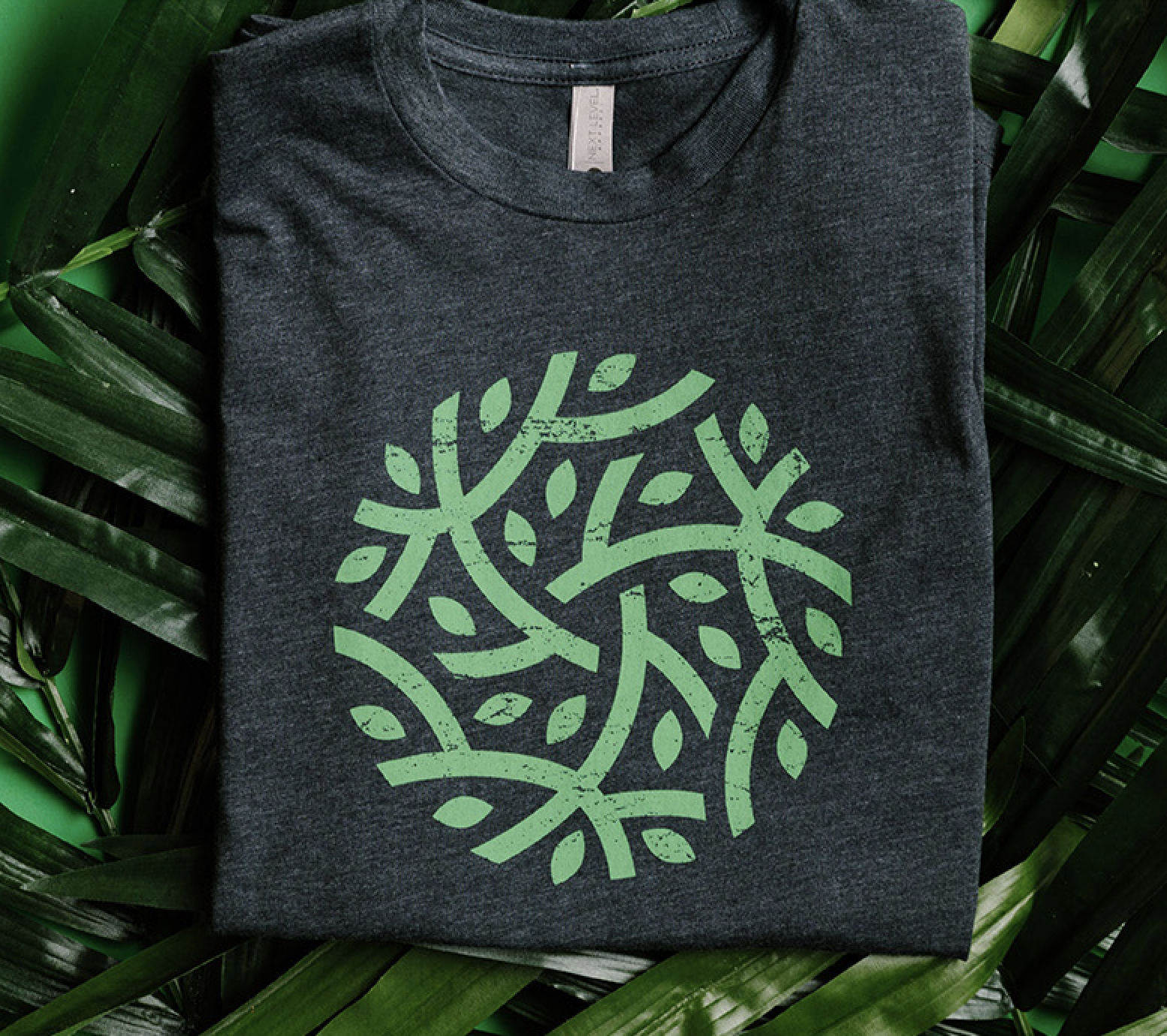 A shirt with a green plant design on the front. 