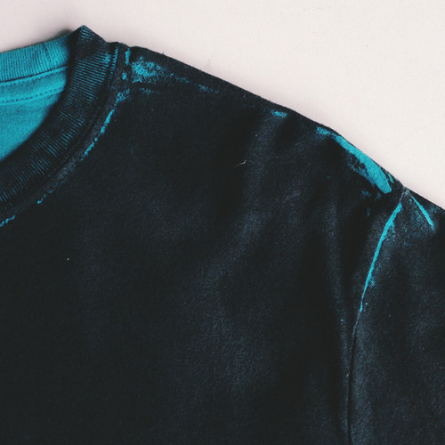 teal shirt with black all over it