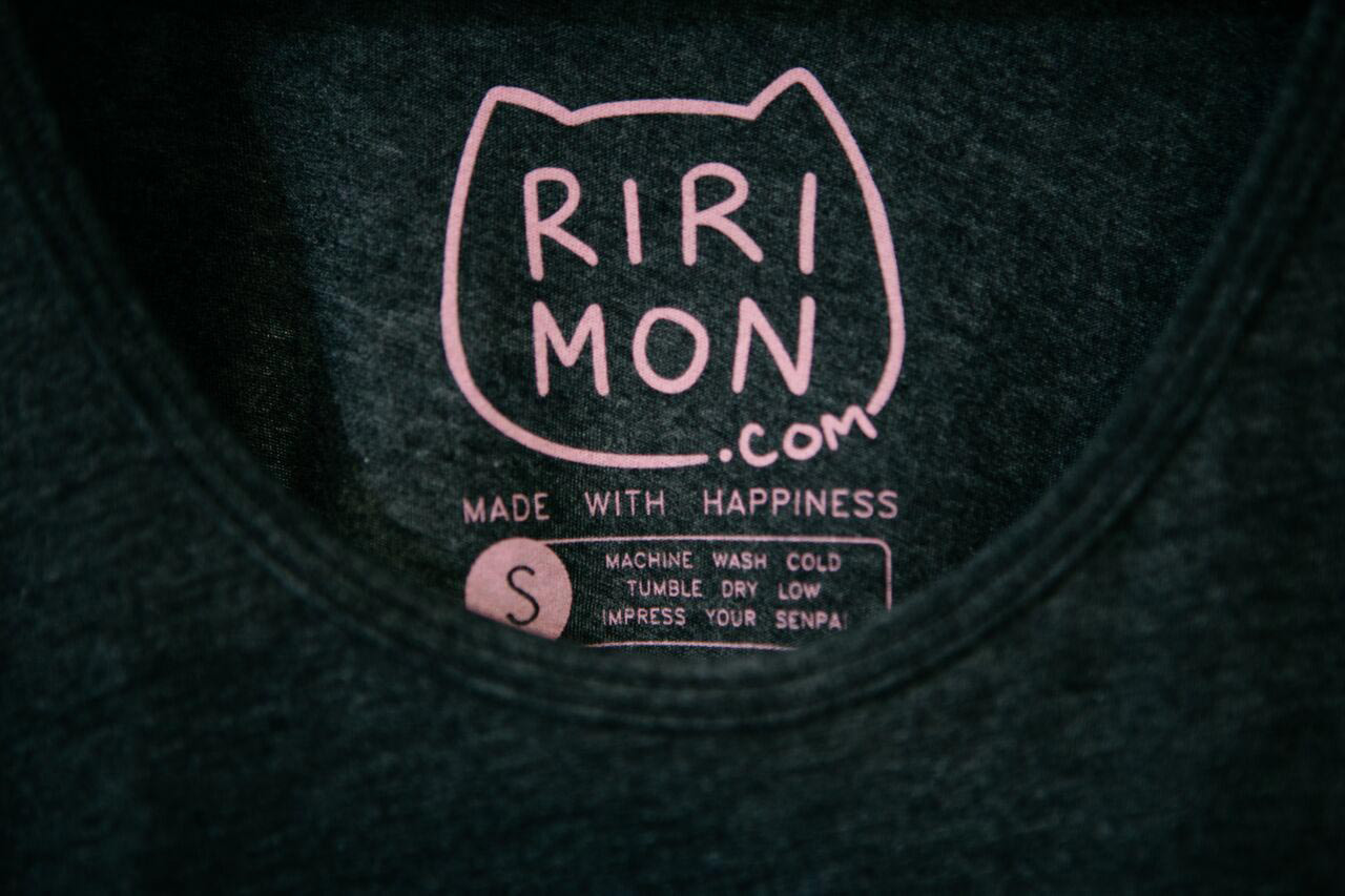 Black shirt with pink cat shaped printed tag