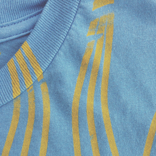 close of up yellow print seam of blue shirt