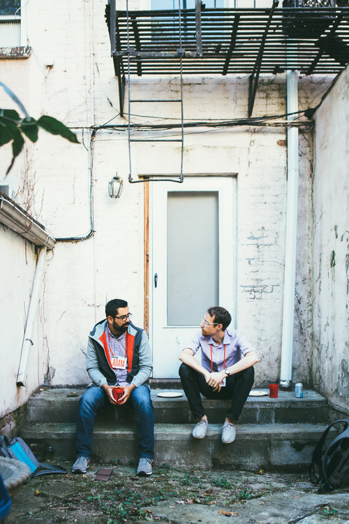 two men sitting on steps