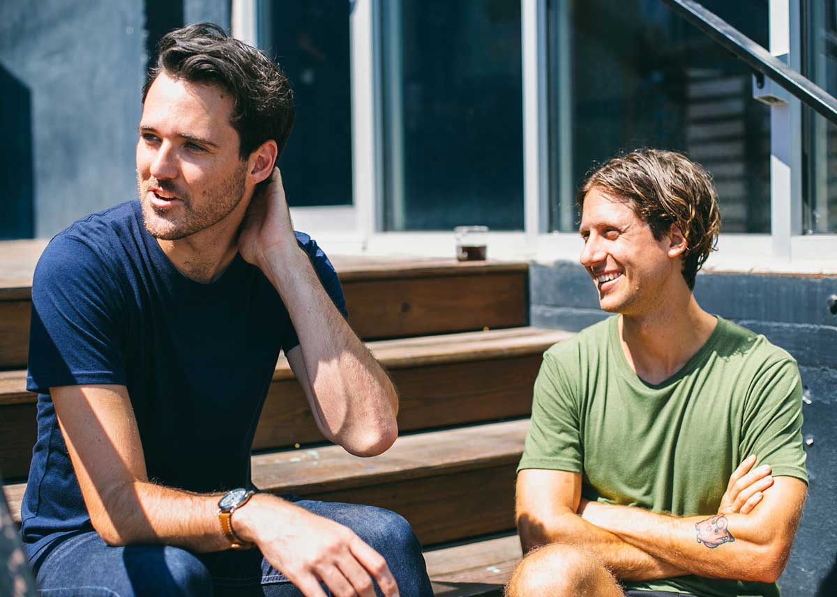 two men sitting on steps