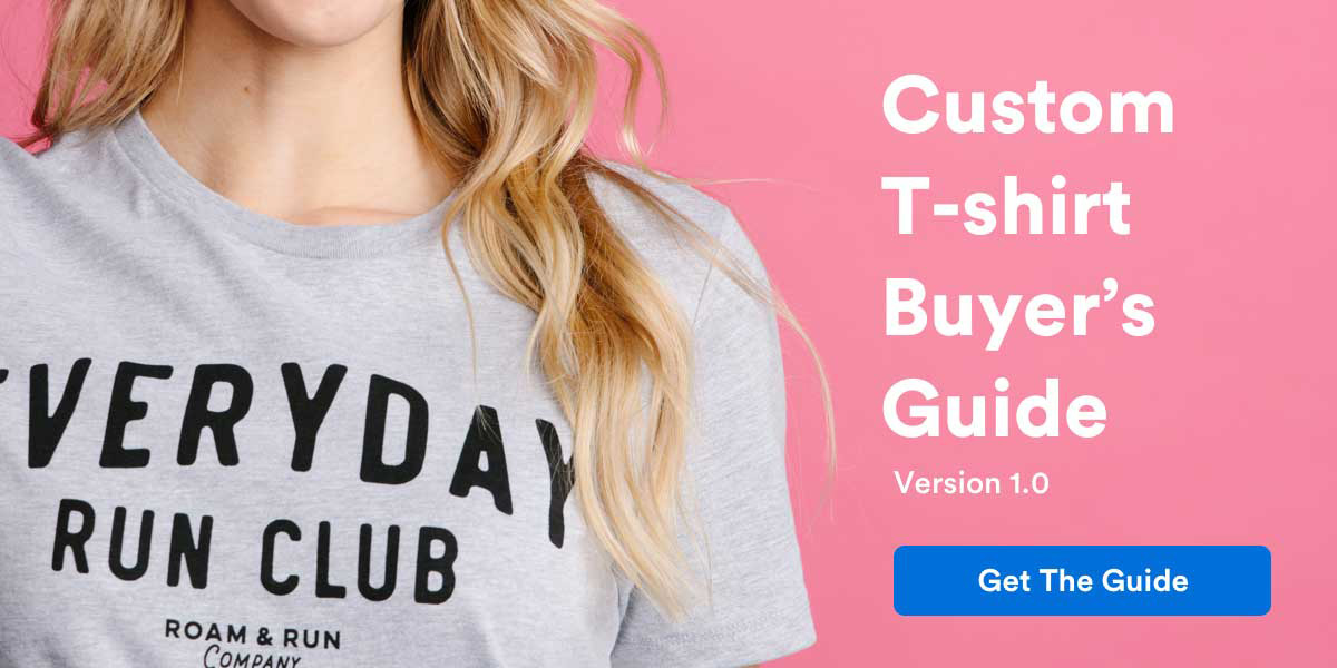 close up picture of blond hair wearing grey shirt with black type