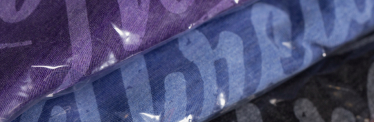 close image of shirts in polybagging