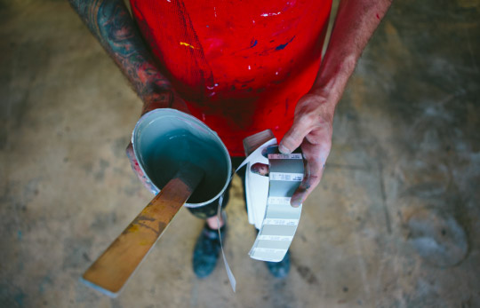 man holding ink mixing supplies