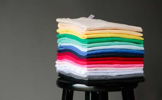 stack of folded colorful shirts