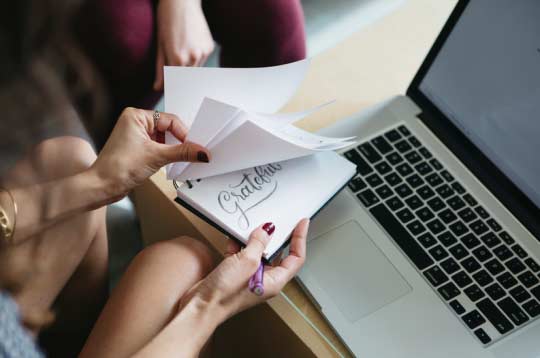 hand flipping pages of sketch book