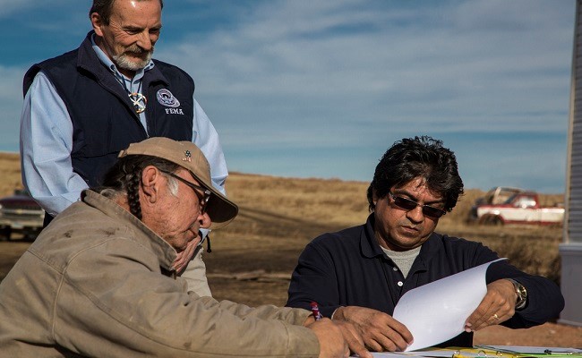 FEMA personnel and an Applicant discussing a title to a facility.