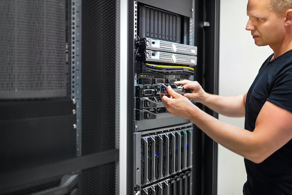 Image of man at a server rack