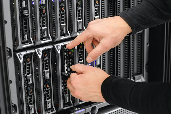 Image of hands working in a server rack