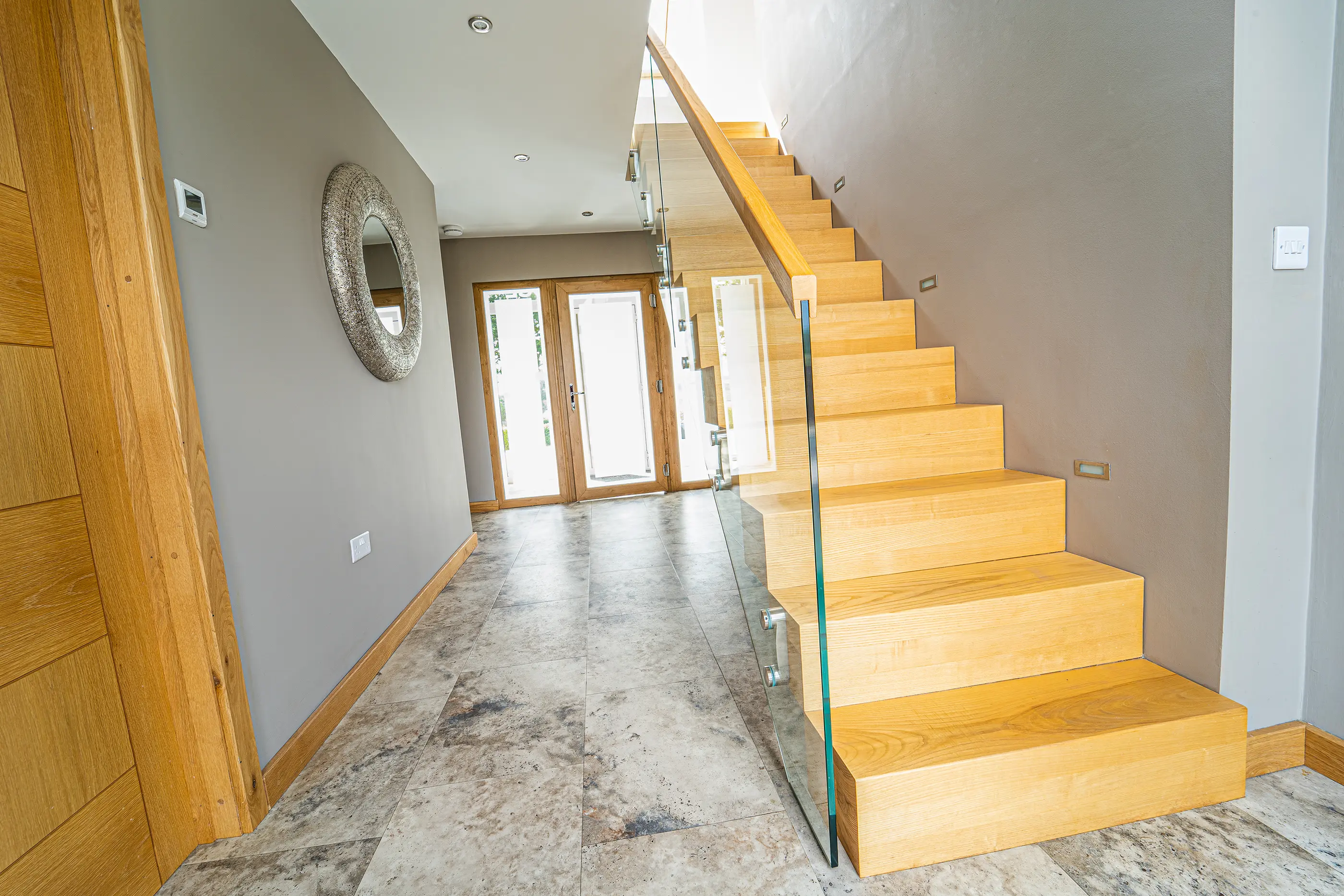 Modern timber staircase design with glass balustrade designed by WK Design Architects