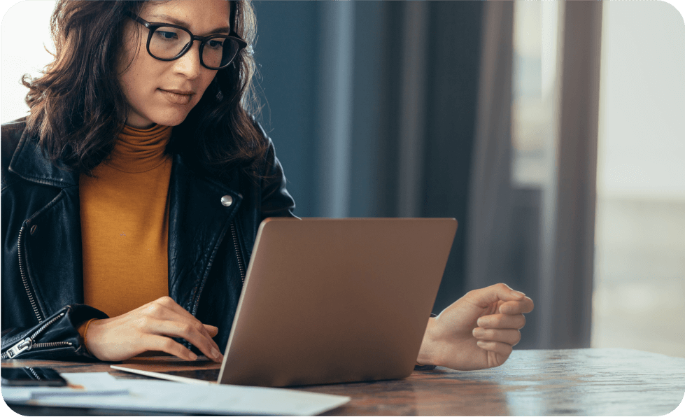 Woman in glasses working on a laptop