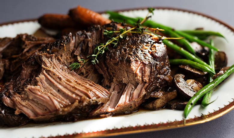 Slow cooked beef cut with vegetables and herbs