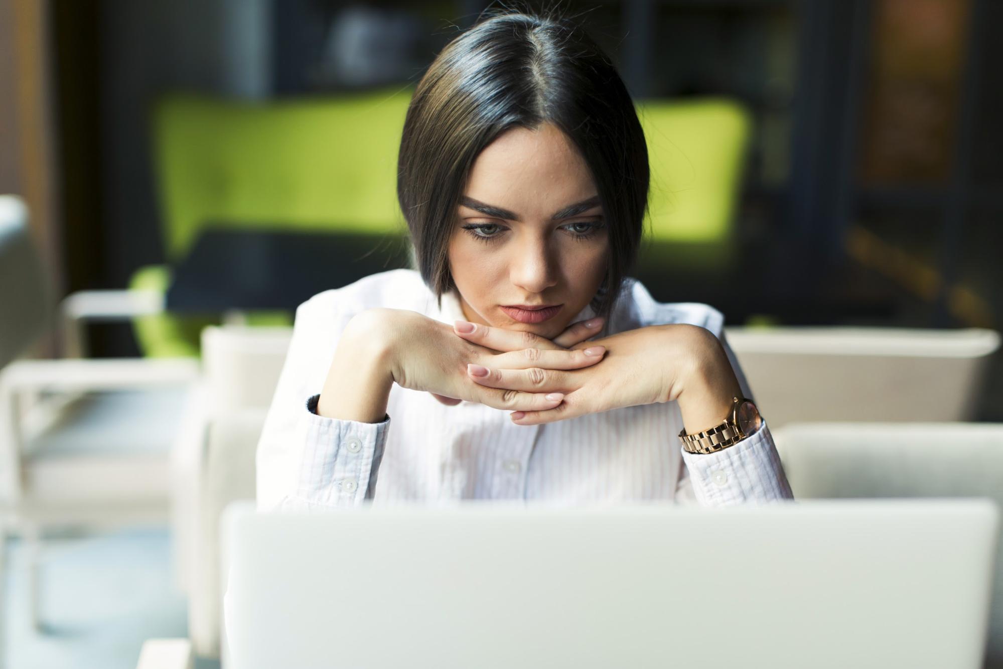 focused woman working with laptop