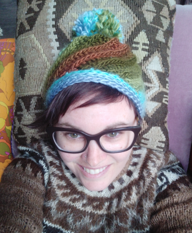 Photo of Carlie wearing a beanie.
