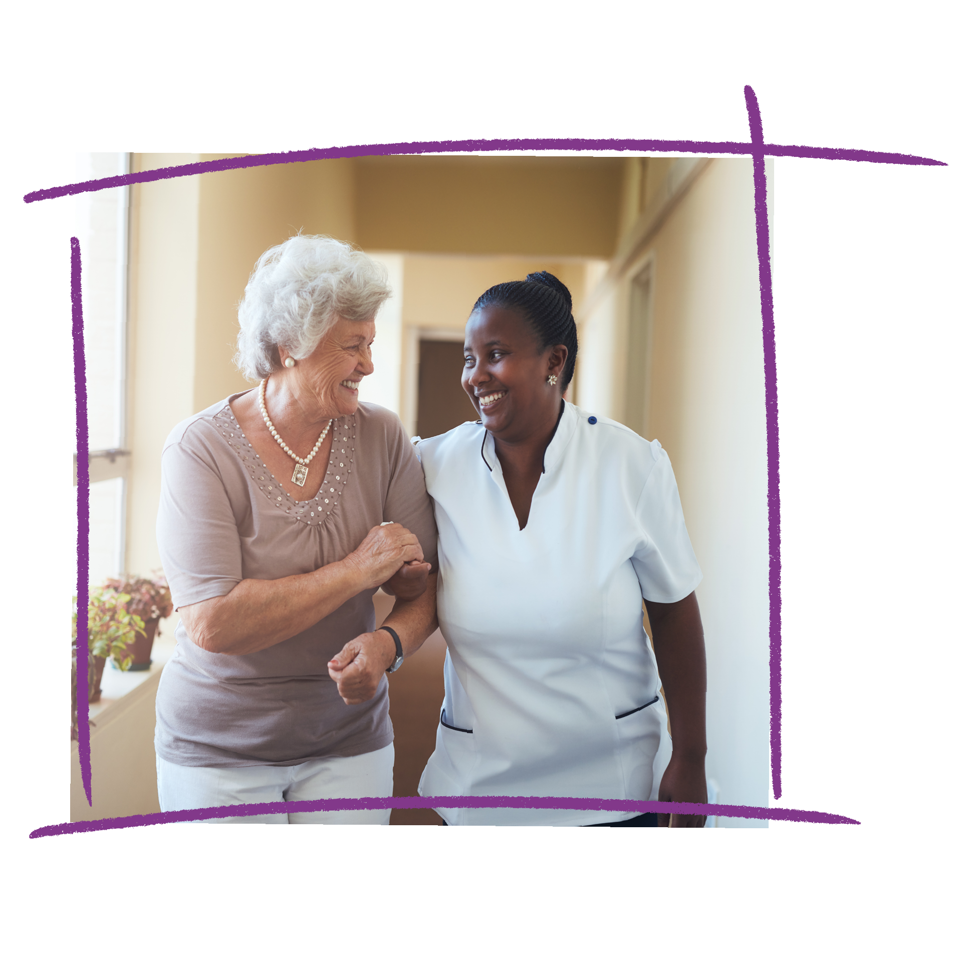 Photo of an older woman linking arms with a nurse wearing a white uniform. They are walking down a hallway together.