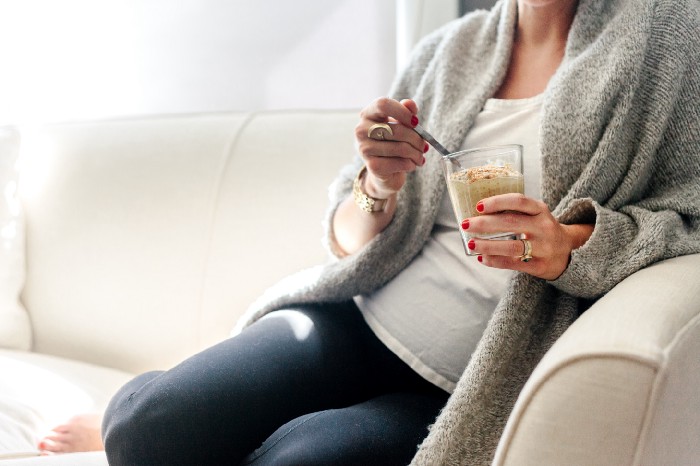 pregnant woman eating smoothie