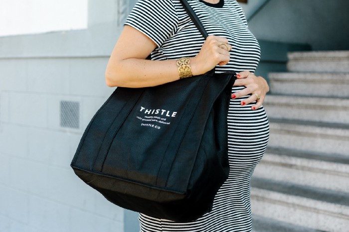 pregnant woman with thistle bag