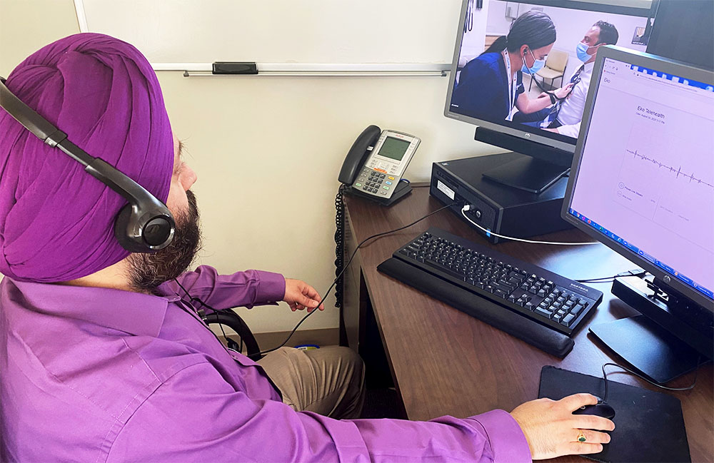 Dr. Singh directs telehealth exam.