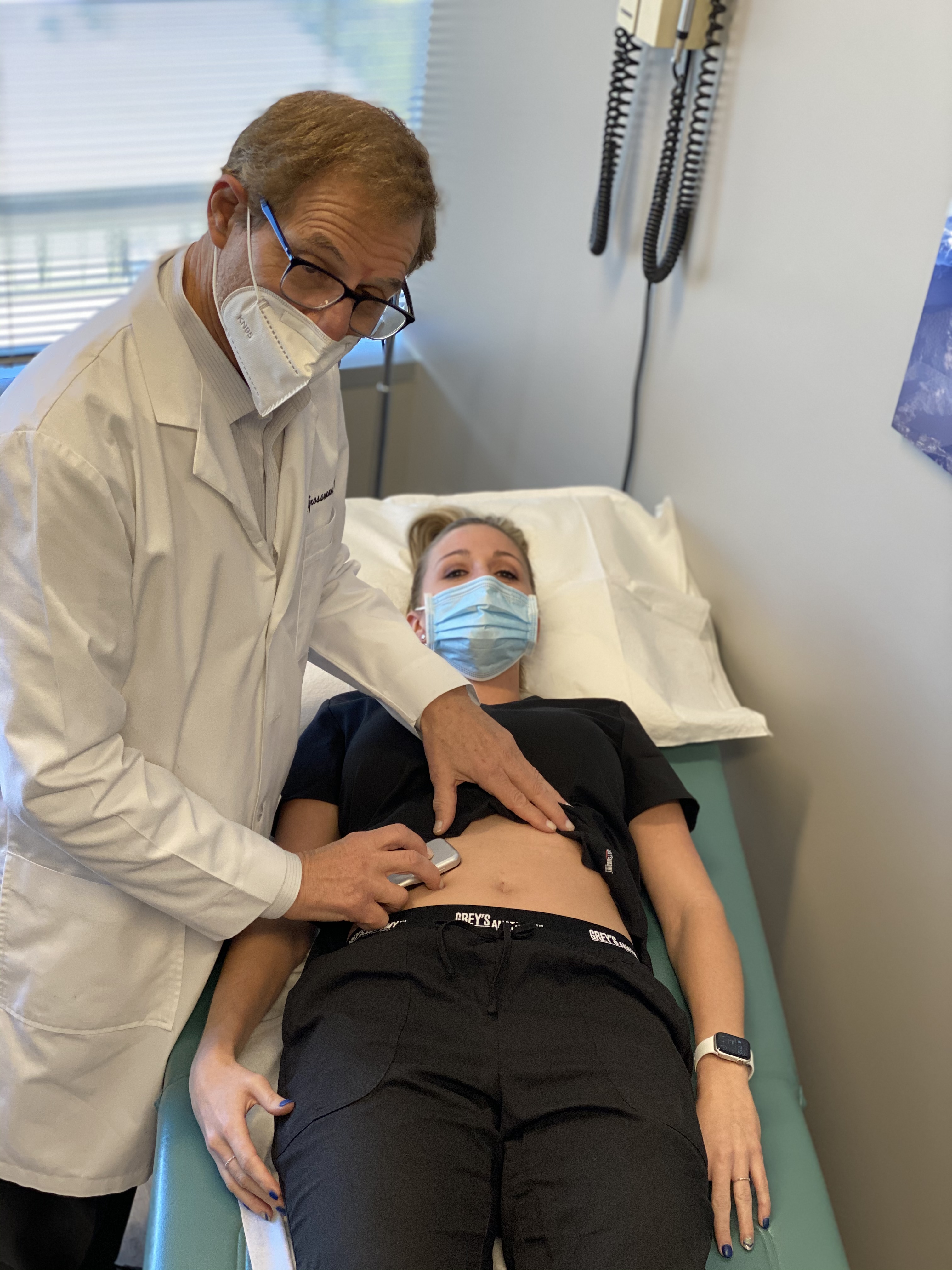 Dr. Grossman auscultating abdominal sounds with the Eko DUP