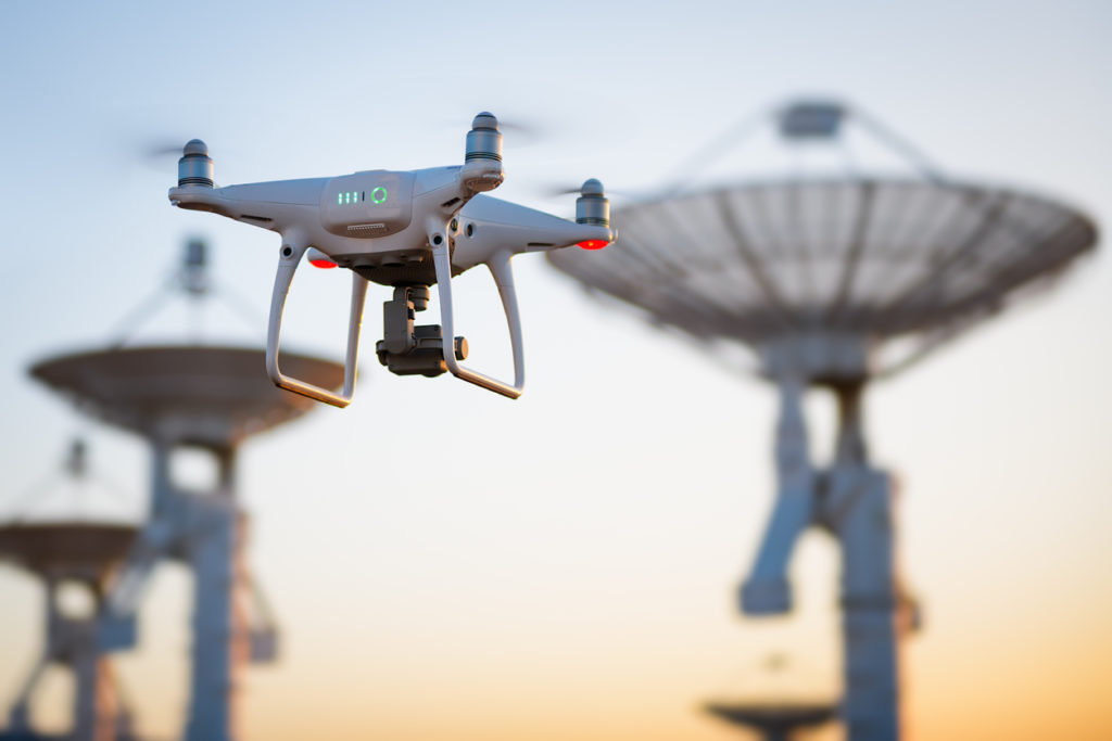 Drone flying next to radio antennas
