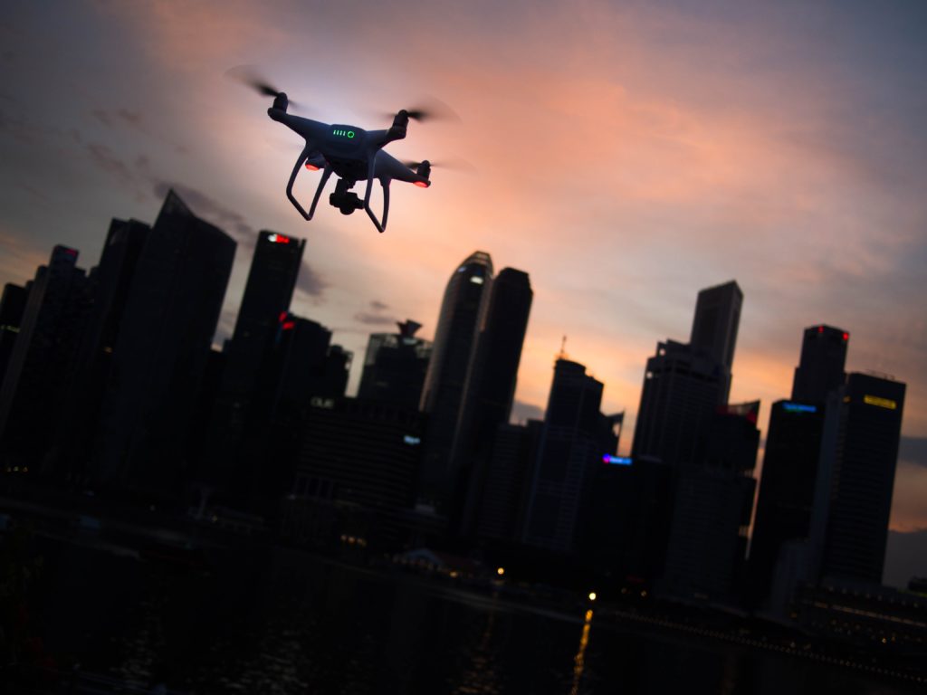 Drone flying against a city skyline