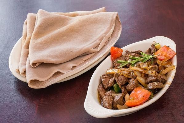 <strong>Dukem Special Tibs: </strong>Cubed tender lamb or beef fried marinated with Dukem special sauce, sautéed with onion r