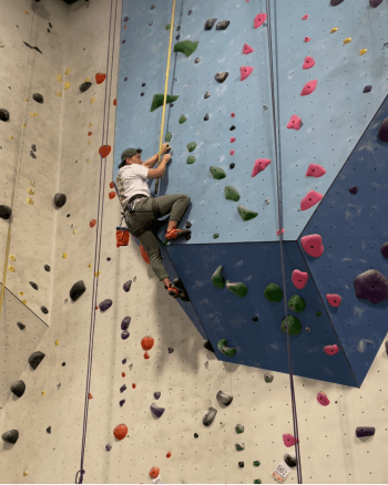 Sam rock climbing during their day off.