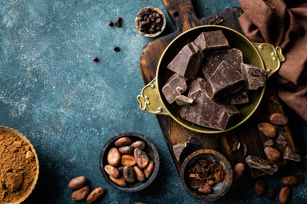 A variety of chocolate on a cutting board.