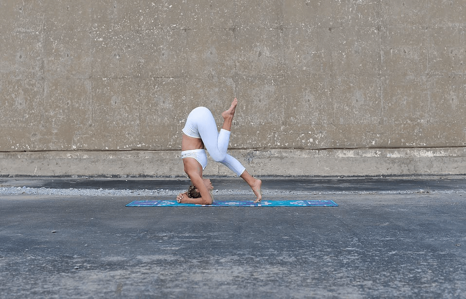 Bring in one knee for the next step of doing a headstand.