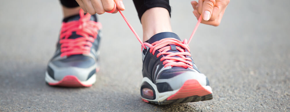 A person tying their running shoes.