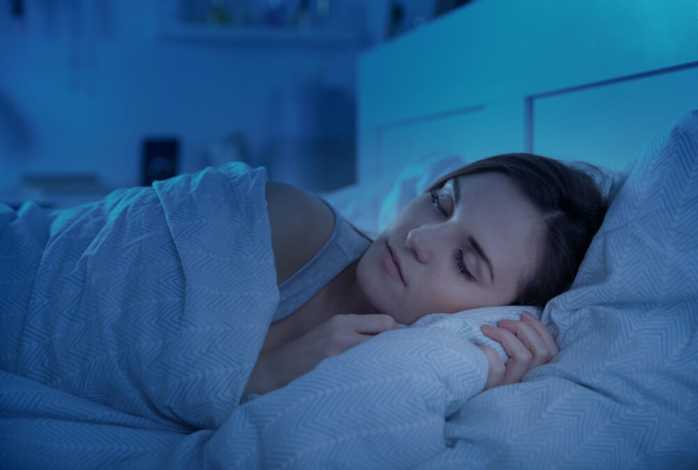 A woman peacefully sleeping on her side.