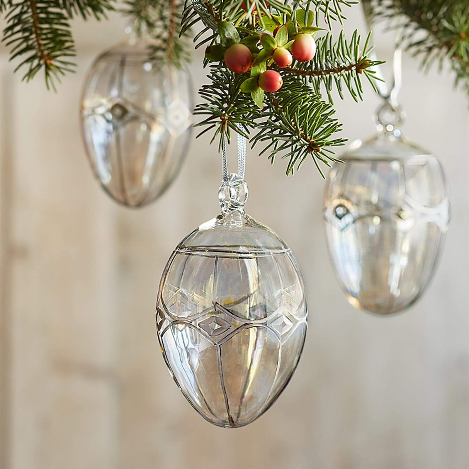 Brilliant Glass Egg Ornaments hanging from a tree.