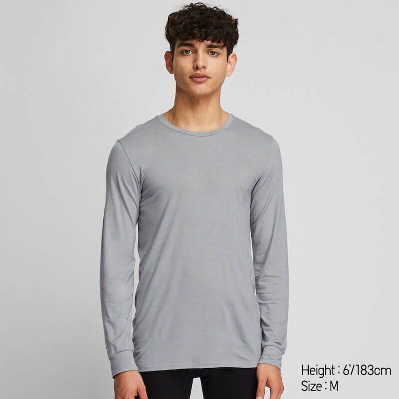 A man wearing a gray, long-sleeved Uniqlo heattech undershirt.