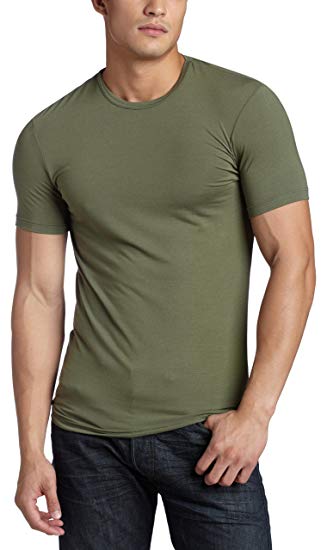 A man wearing a tight-fitting olive t-shirt from Calvin Klein.