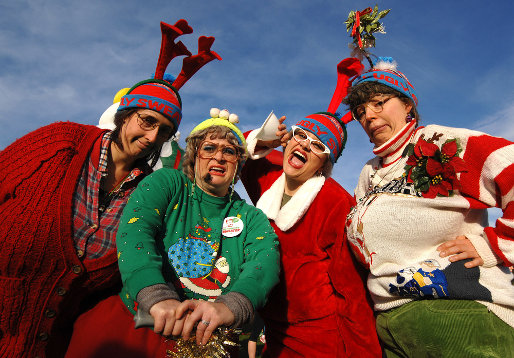 A group of people in Ugly Christmas sweaters.